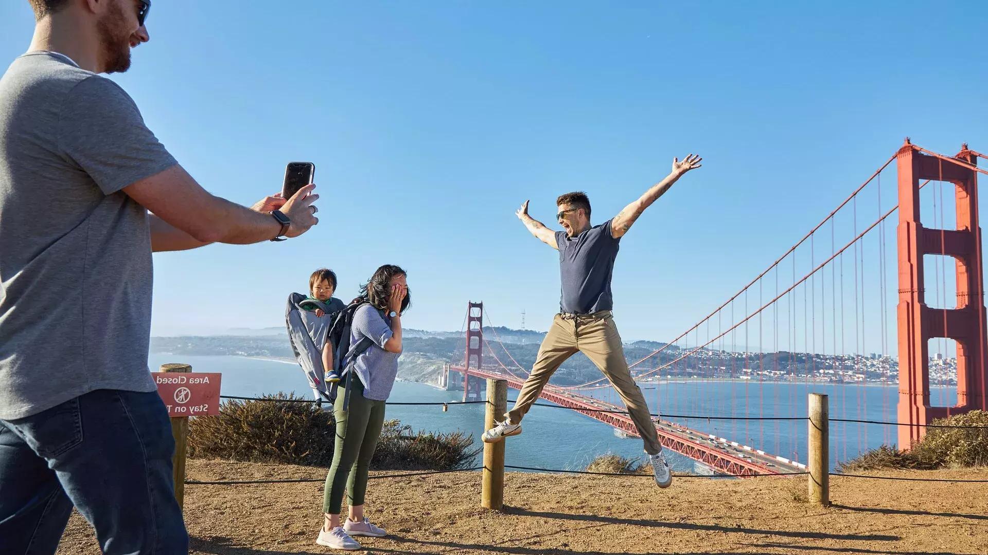 A group taking photos at the Golden Gate Bridge