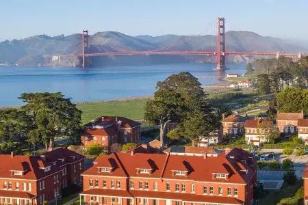 Aerial of the Walt Disney Family Museum with the Golden Gate Bridge in the background
