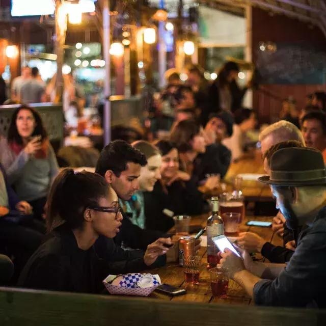 People eating in a crowded dining area in SoMa. San Francisco, California.