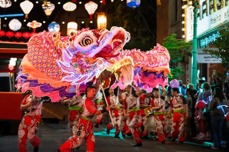Dancers manipulate a giant, illuminated dragon during San Francisco's Lunar New Year Parade.